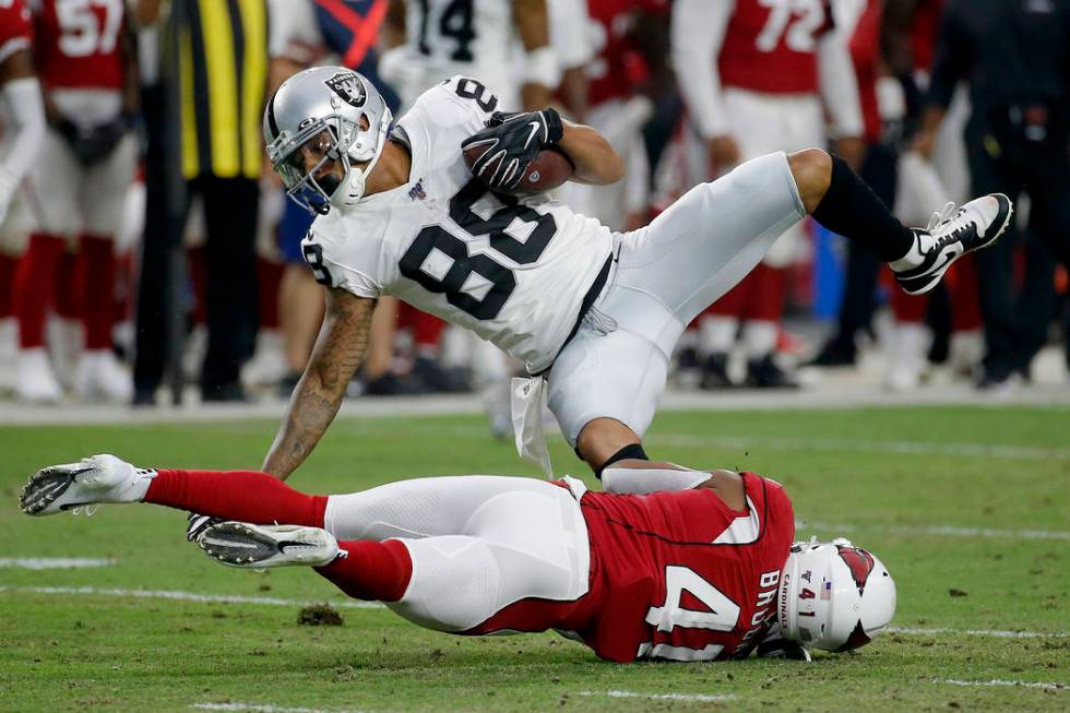 Oakland Raiders wide receiver Marcell Ateman (88) is hit by Arizona Cardinals defensive back Na ...