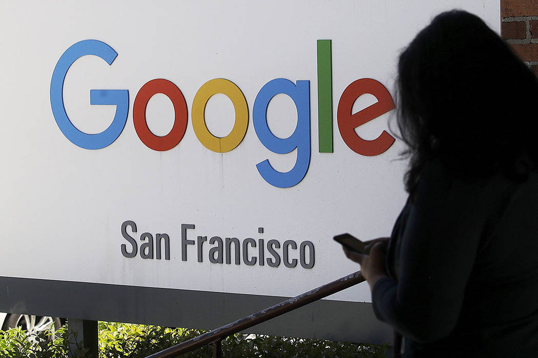 FILE - In this May 1, 2019, file photo, a person walks past a Google sign in San Francisco. Goo ...