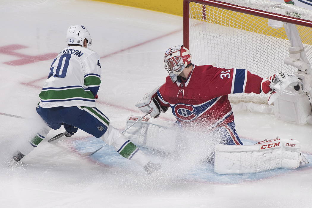 Vancouver Canucks' Elias Pettersson moves in on Montreal Canadiens goaltender Carey Price durin ...