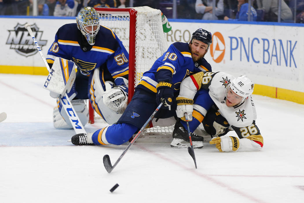 St. Louis Blues' goalie Jordan Binnington (50) and Ryan O'Reilly (90) defend the goal against V ...