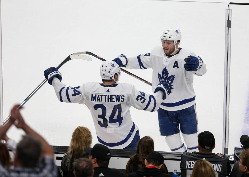 Toronto Maple Leafs defenseman Morgan Rielly (44) skates up to Toronto Maple Leafs center Austo ...