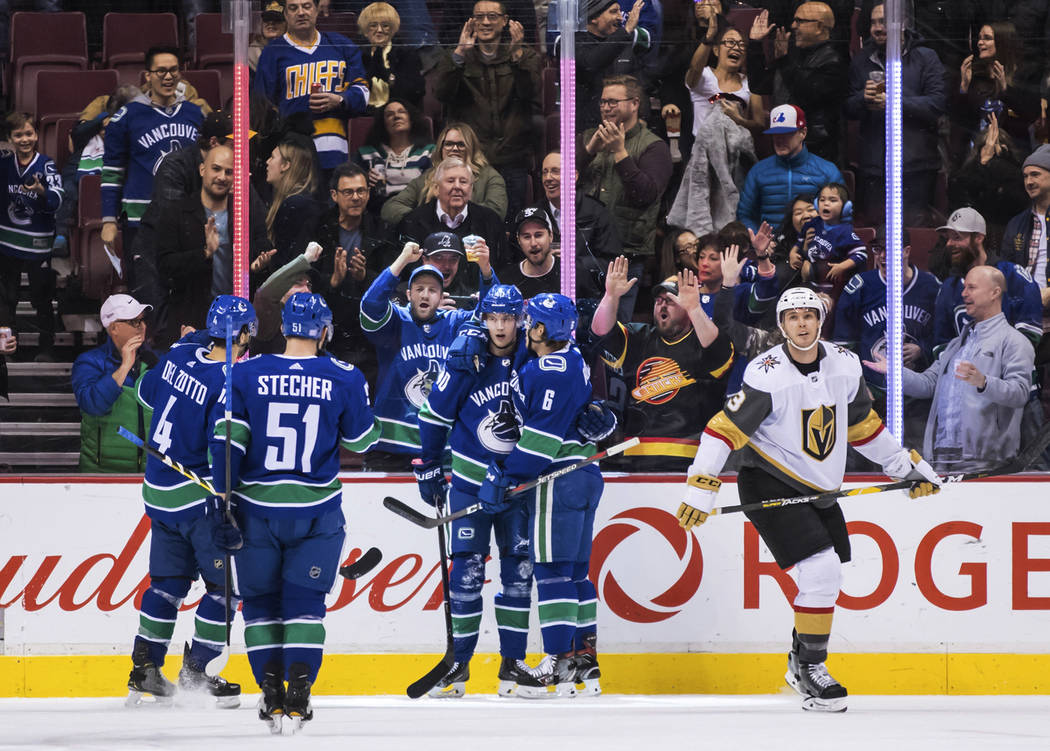 Vancouver Canucks' Michael Del Zotto, Troy Stecher, Elias Pettersson and Brock Boeser, from lef ...