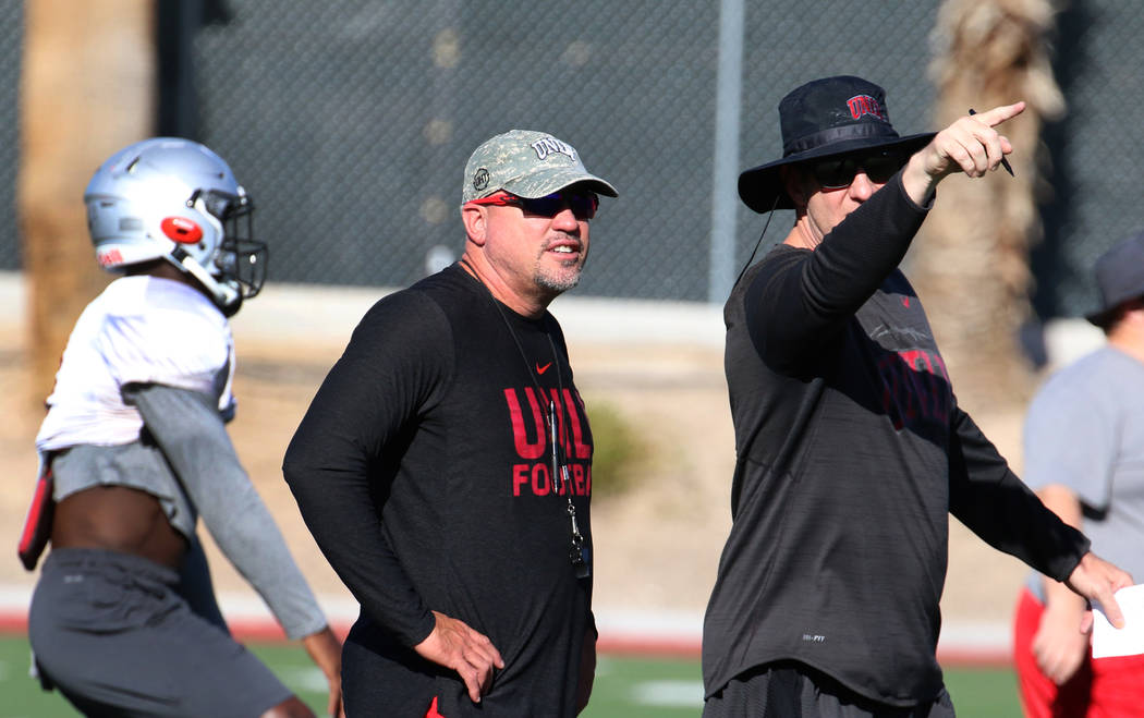 UNLV Rebels head coach Tony Sanchez, center, and quarterbacks coach Ron O'Dell, second right, w ...