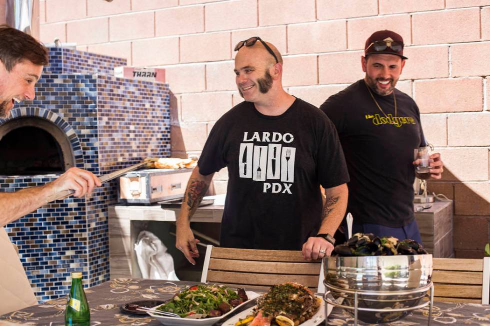 John Courtney, chef of Block 16 at The Cosmopolitan of Las Vegas hotel-casino, center, laughs w ...