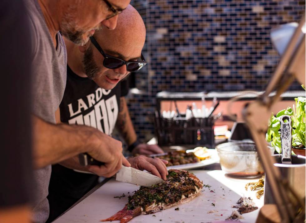 John Courtney, chef of Block 16 at The Cosmopolitan of Las Vegas hotel-casino, center, gets hel ...