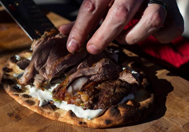 Matt Silverman, chef for HEXX Kitchen + Bar, prepares rotisserie lamb on flat bread with tzatzi ...