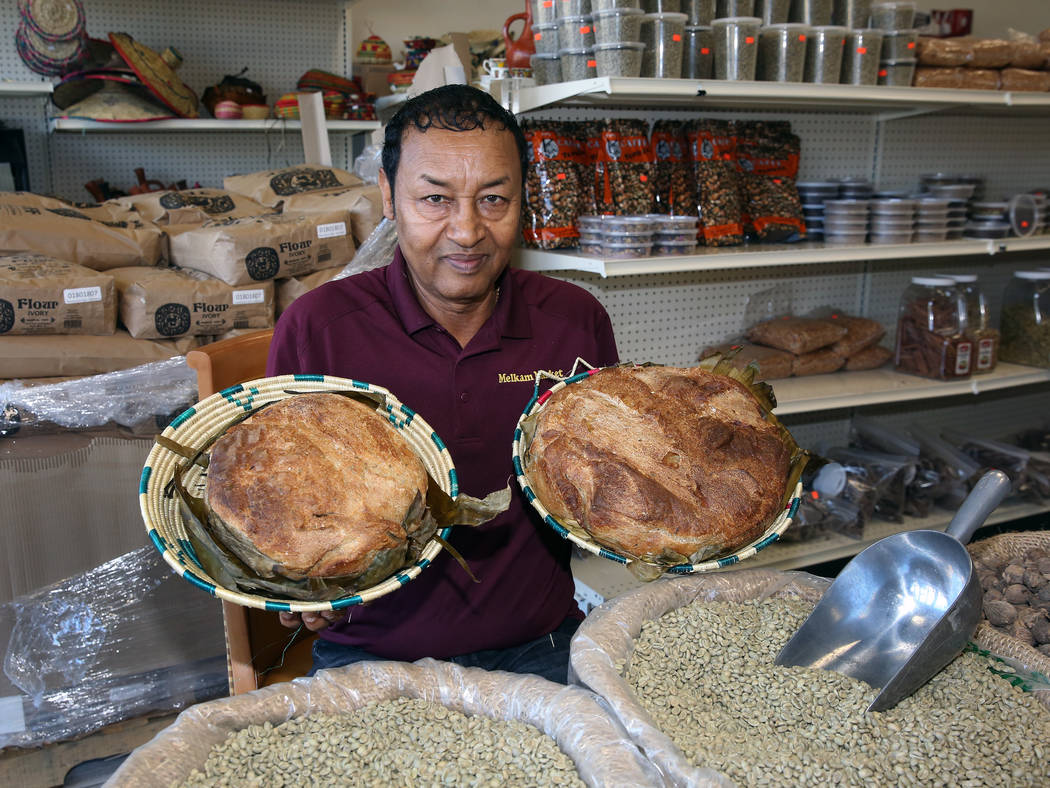 Legesse Tigabu, owner of Melkam Market, an Ethiopian store, poses for photo, holding home made ...