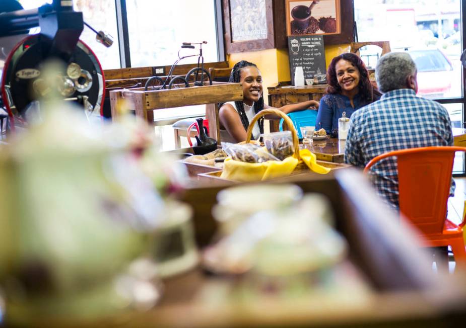 Semira Abraham, left, with her mother, Weini, and father, Tekle, at Java Tree at Flamingo Road ...