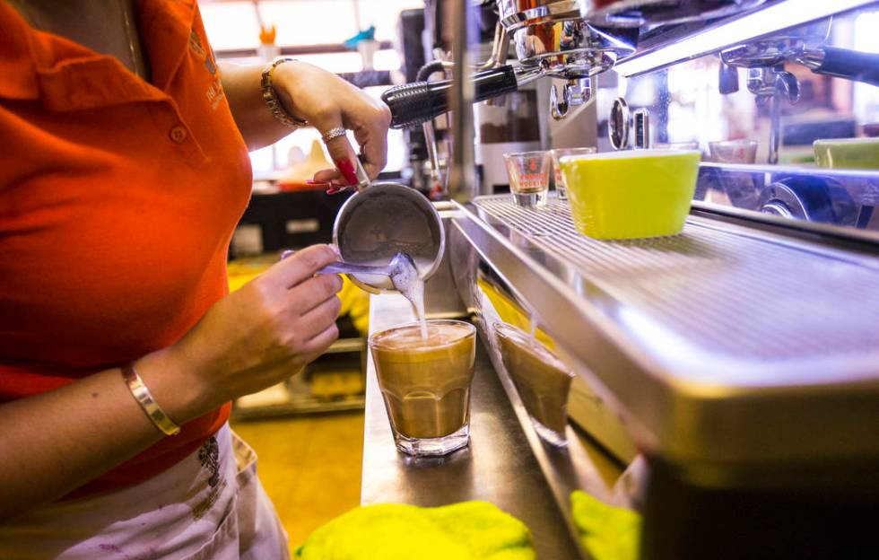 Gio Marongiu, store manager at Java Tree, prepares coffee at the store at Flamingo Road and Dec ...