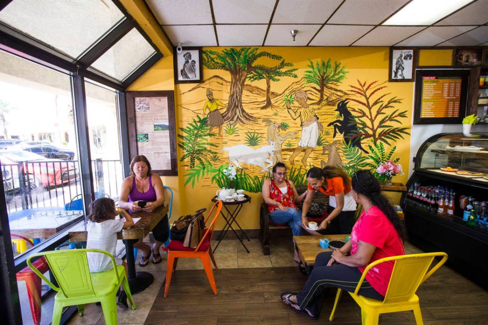 Gio Marongiu, store manager at Java Tree, second from right, serves coffee for Saba at Java Tre ...