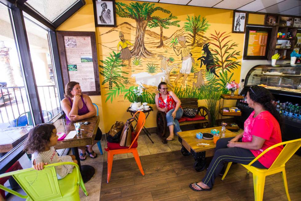 Brenda Colon, upper left, of Las Vegas, waits for tea and coffee to be served while sitting wit ...