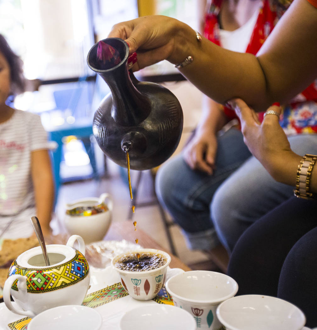 Gio Marongiu, store manager at Java Tree, pours coffee in a traditional Ethiopian coffee ceremo ...