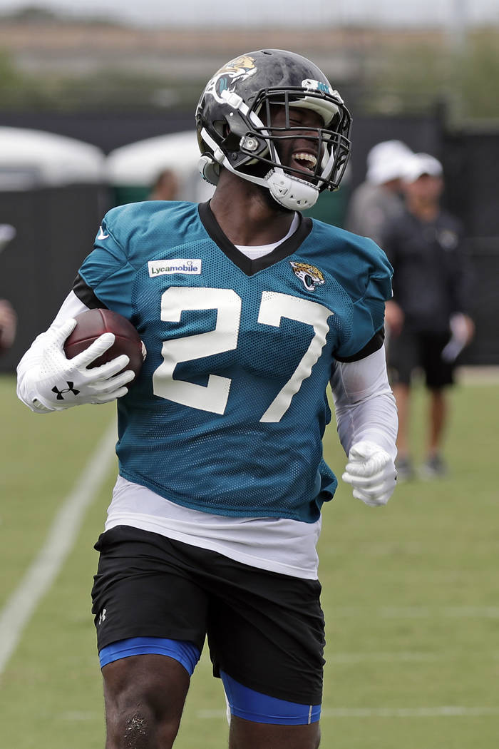 Jacksonville Jaguars running back Leonard Fournette (27) runs with the ball during an NFL footb ...