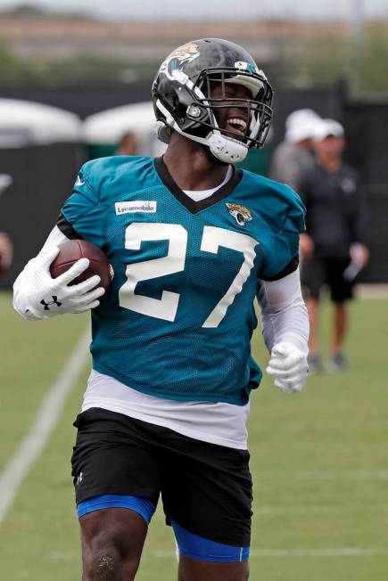 Jacksonville Jaguars running back Leonard Fournette (27) runs with the ball during an NFL footb ...