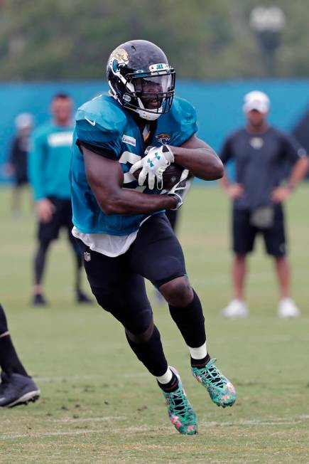 Jacksonville Jaguars running back Leonard Fournette gains yardage during an NFL football practi ...