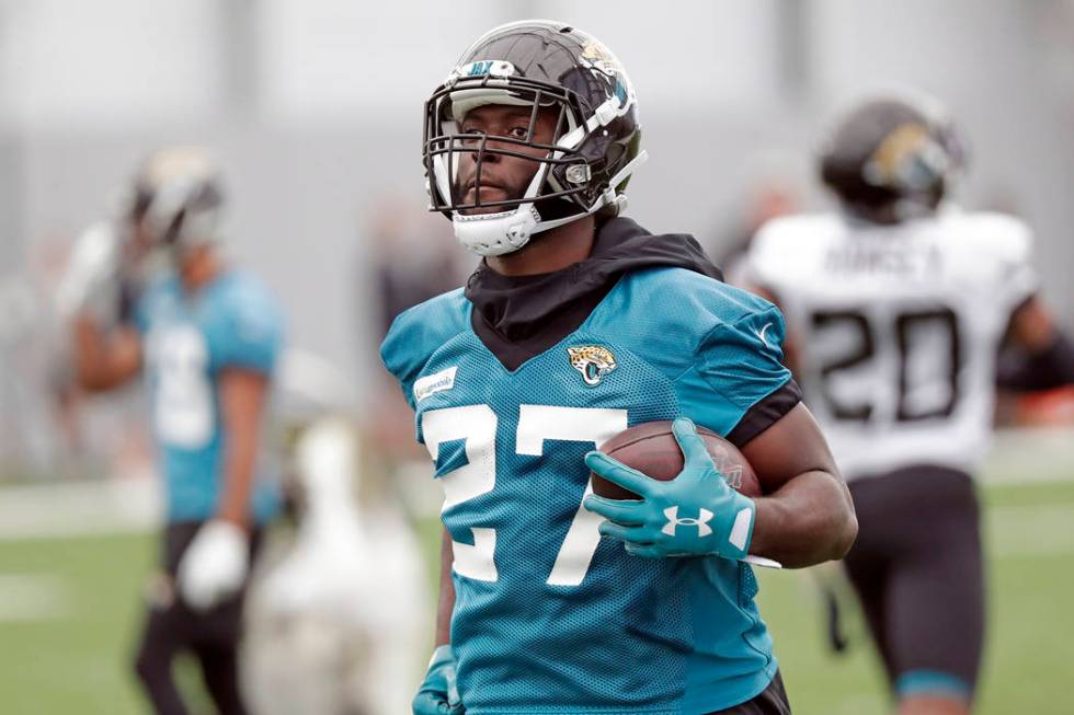 Jacksonville Jaguars running back Leonard Fournette runs with the ball during an NFL football p ...