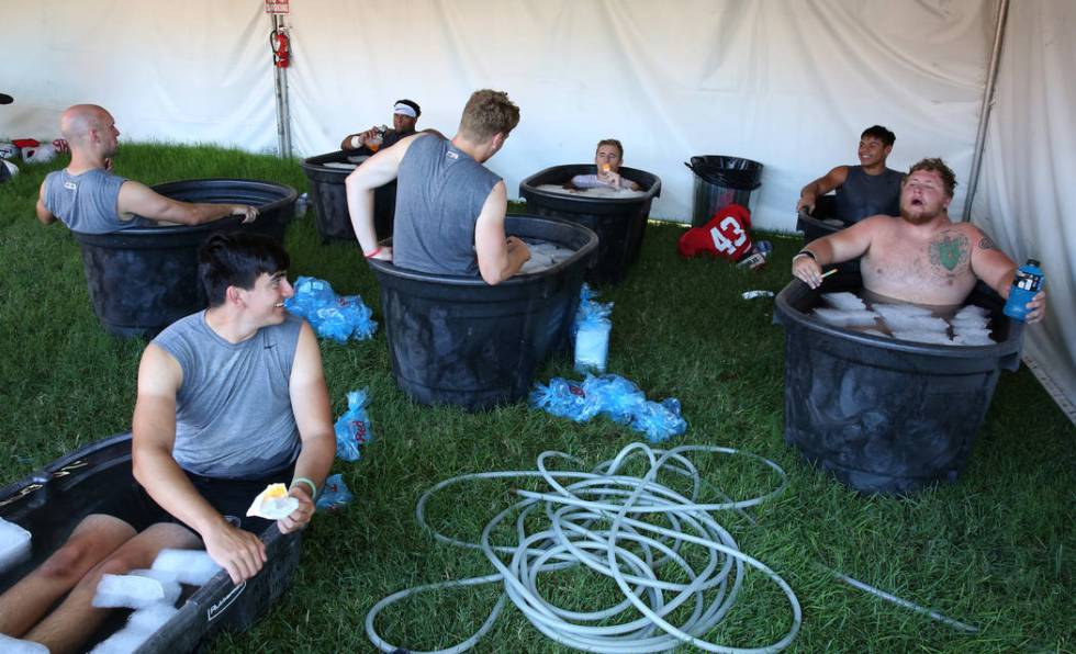 UNLV football players, including kicker Evan Silva, front, and offensive lineman Jackson Reynol ...