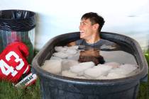 UNLV 's linebacker Malakai Salu, cools off in an ice bath after their football practice on Tues ...