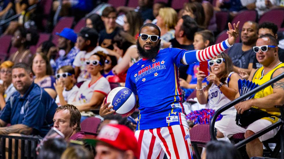 Harlem Globetrotter Speedy Artis (43) shows off for the crowd with a trick shot during their 20 ...