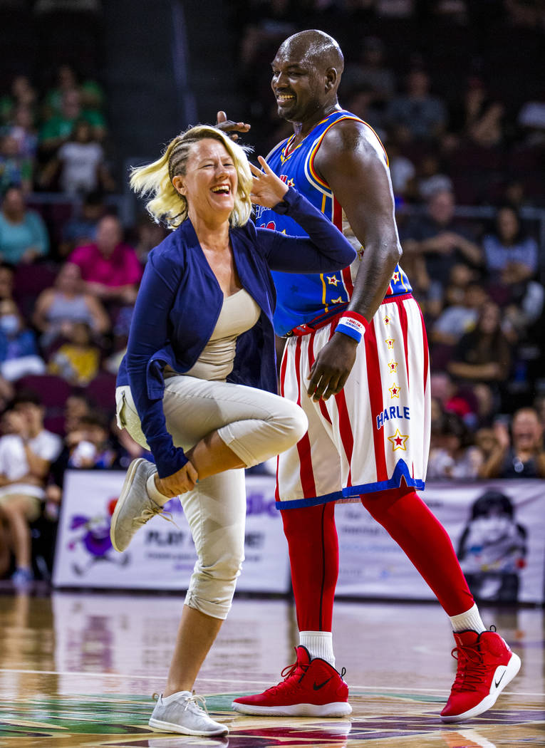 Fan Kelly Perone dances for Harlem Globetrotter Big Easy Lofton (52) who finds it funny during ...