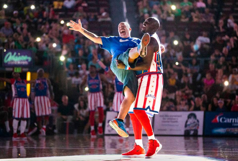 Harlem Globetrotter Big Easy Lofton (52, right) dances under a spotlight with fan Frank Perone ...