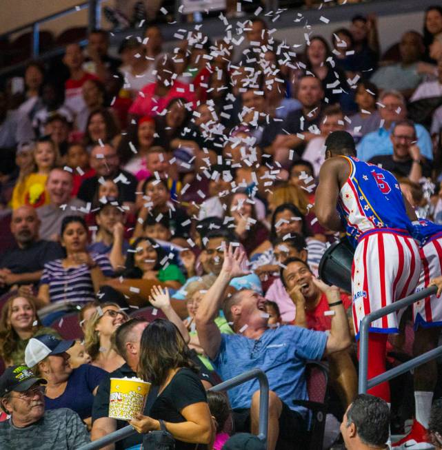 Harlem Globetrotter Bulldog Mack (5) throws a bucket of paper on the crowd pretending it was wa ...