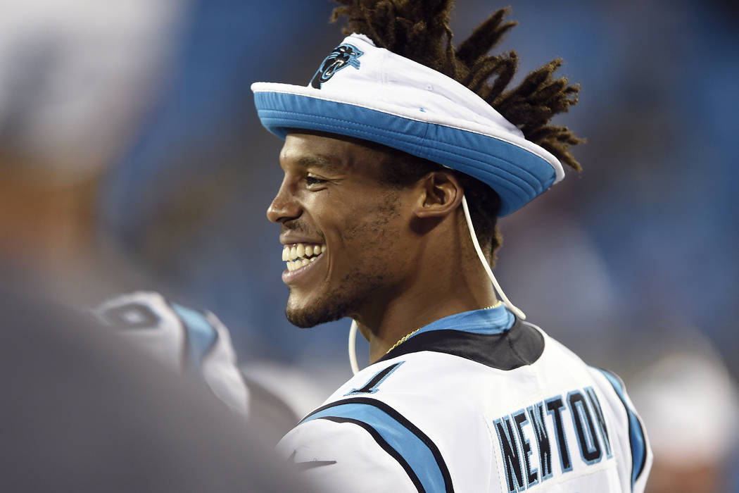 Carolina Panthers quarterback Cam Newton smiles from the sidelinesduring the second half an NFL ...