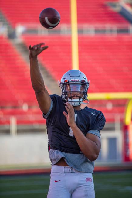 Quarterback Armani Rogers (1) passes to a receiver during the UNLV football team scrimmage at S ...