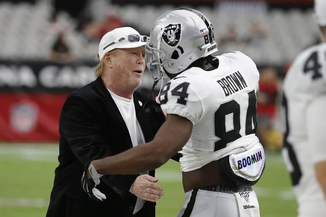 Oakland Raiders wide receiver Antonio Brown (84) embraces owner Mark Clark Davis prior to an NF ...