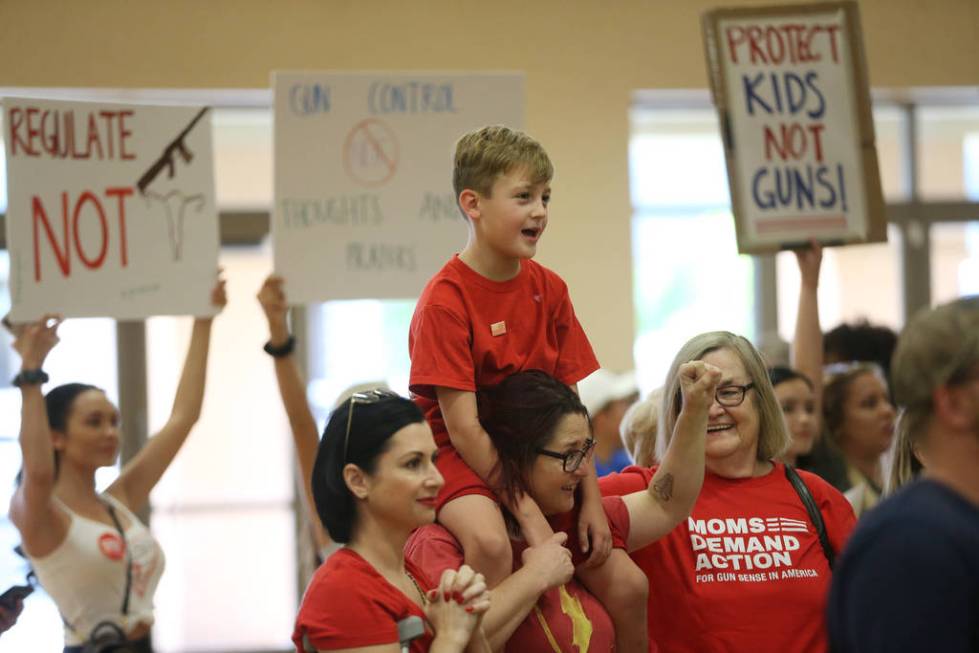 Shawna Stafford, 8, center, of Las Vegas, carries her son Ty, 8, with her sister Melja, left, a ...