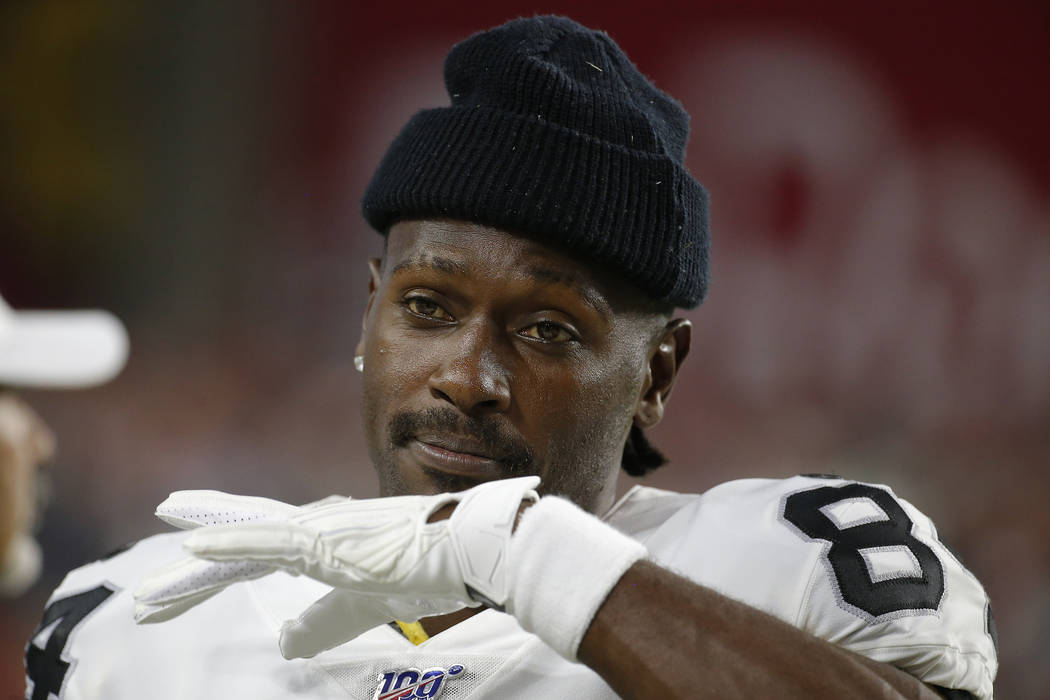 Oakland Raiders wide receiver Antonio Brown watches from the sidelines during the second half o ...