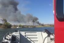Crews battle a brush fire near the Big Bend of the Colorado State Recreation Area on Sunday, Au ...