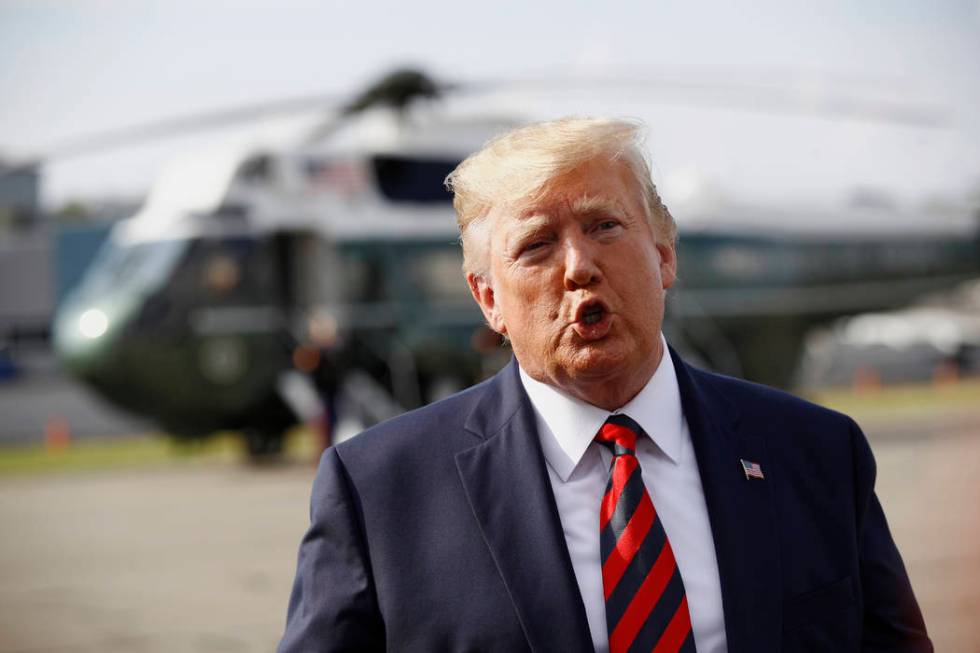 President Donald Trump speaks with reporters before boarding Air Force One at Morristown Munici ...