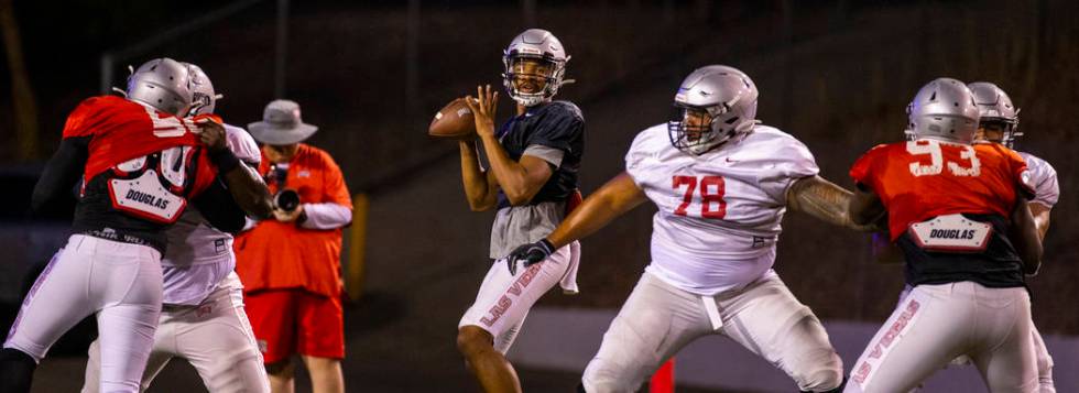 Offensive lineman Justin Polu (78, right center) helps to defend quarterback Armani Rogers (1, ...