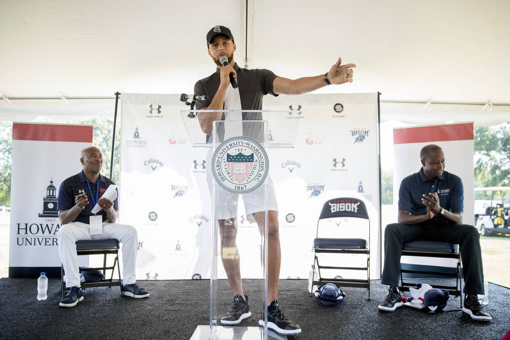 Golden State Warriors guard Stephen Curry speaks as Howard University Athletic Director Kery D ...