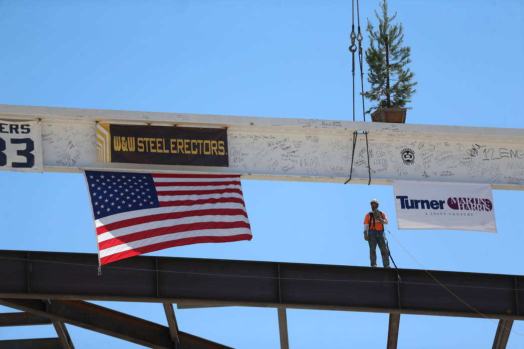 Workers hoist a beam signed by 800 workers on top of the future Las Vegas Convention Center exh ...