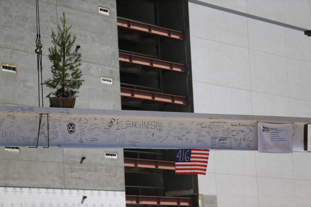 Workers hoist a beam signed by 800 workers on top of the future Las Vegas Convention Center exh ...