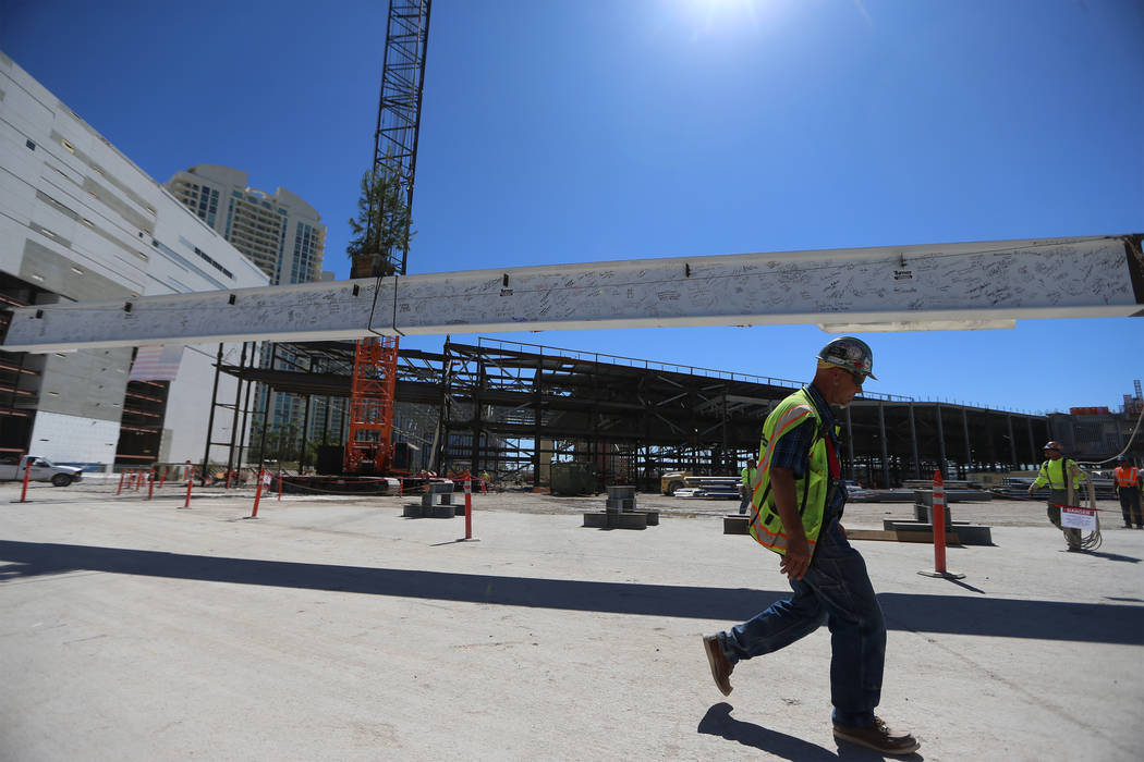 Workers hoist the last high beam on top of the future Las Vegas Convention Center exhibit hall ...