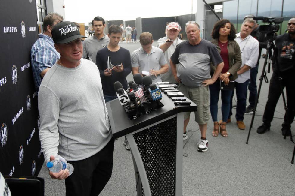 Oakland Raiders head coach Jon Gruden, left, speaks during a news conference after NFL football ...