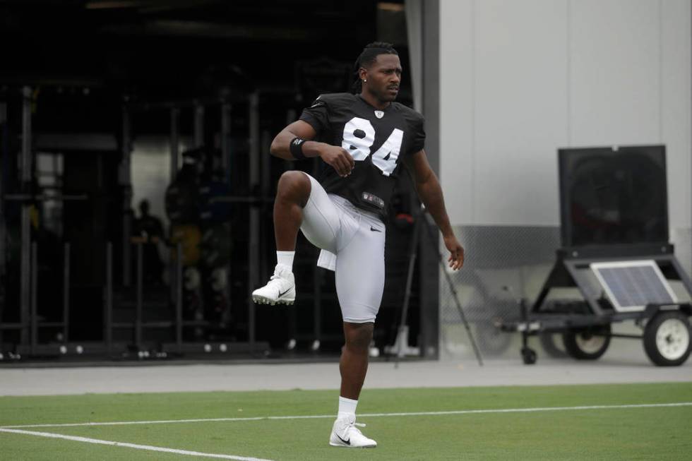 Oakland Raiders' Antonio Brown stretches during NFL football practice in Alameda, Calif., Tuesd ...