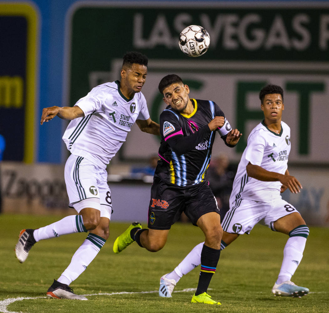 Las Vegas Lights FC forward Irvin Parra (11, center) heads the ball towards the goal between Po ...