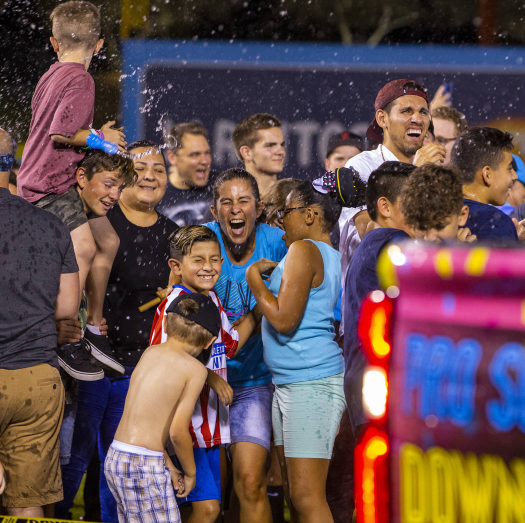 Las Vegas Lights FC fans enjoy a massive water balloon fight on field at halftime during their ...