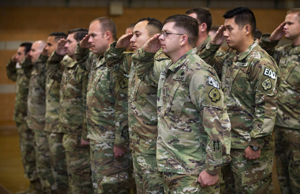 Soldiers with the Nevada Army Guard 3665th Explosive Ordnance Disposal Company salute during a ...