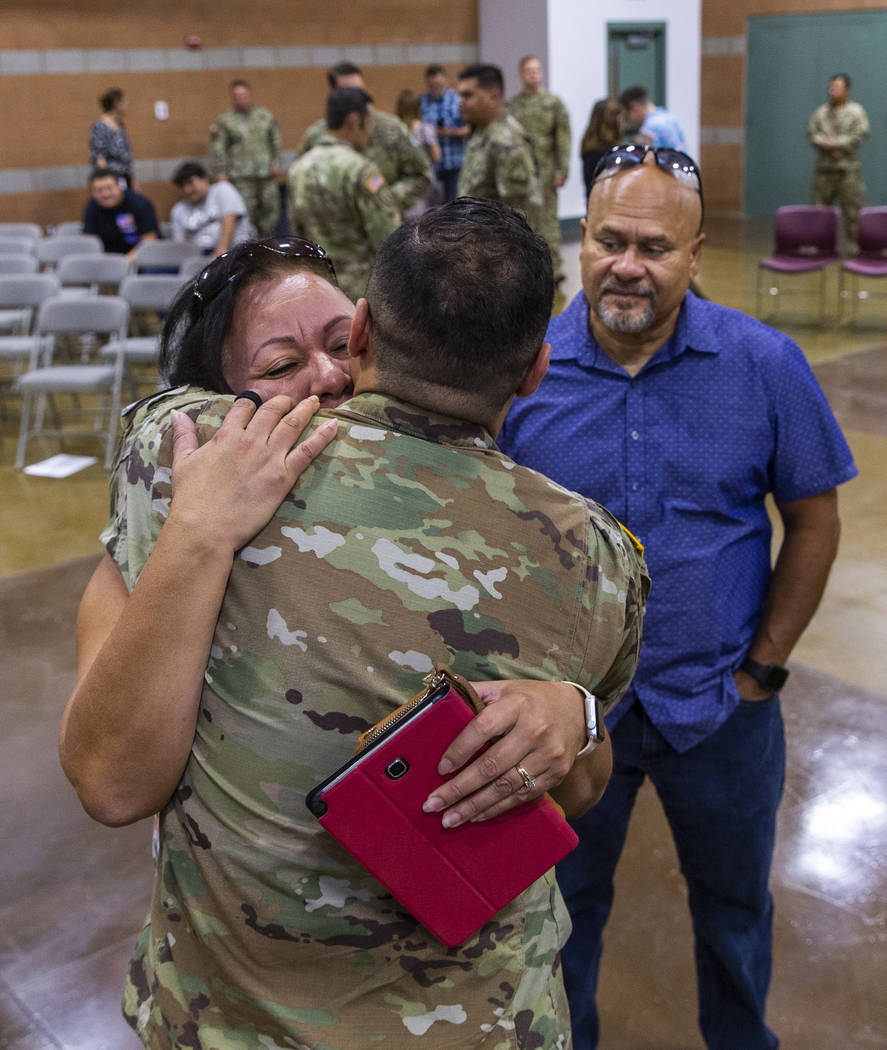 (From left) Maritza Pierluissi hugs her son Sgt. Ulises Pierluissi Jr. goodbye as his father Ul ...