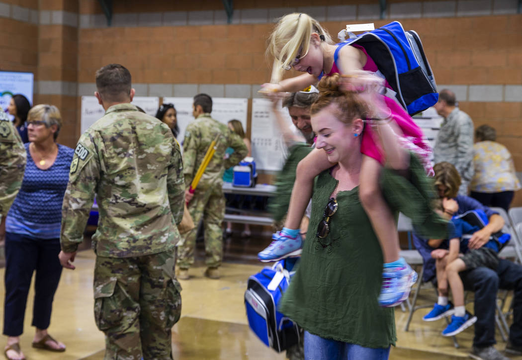 Shawna Henry spins around with Karagan Henry, 5, after a mobilization ceremony for her and othe ...