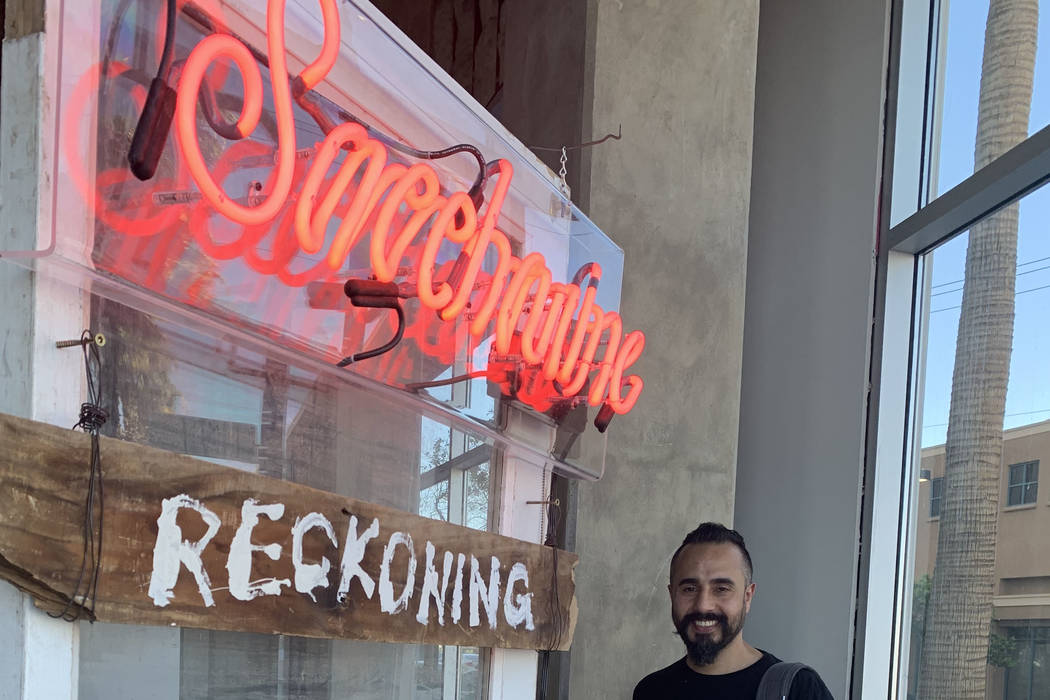 Ali Fathollahi stands next to his exhibit in the downtown area that will be available for viewi ...