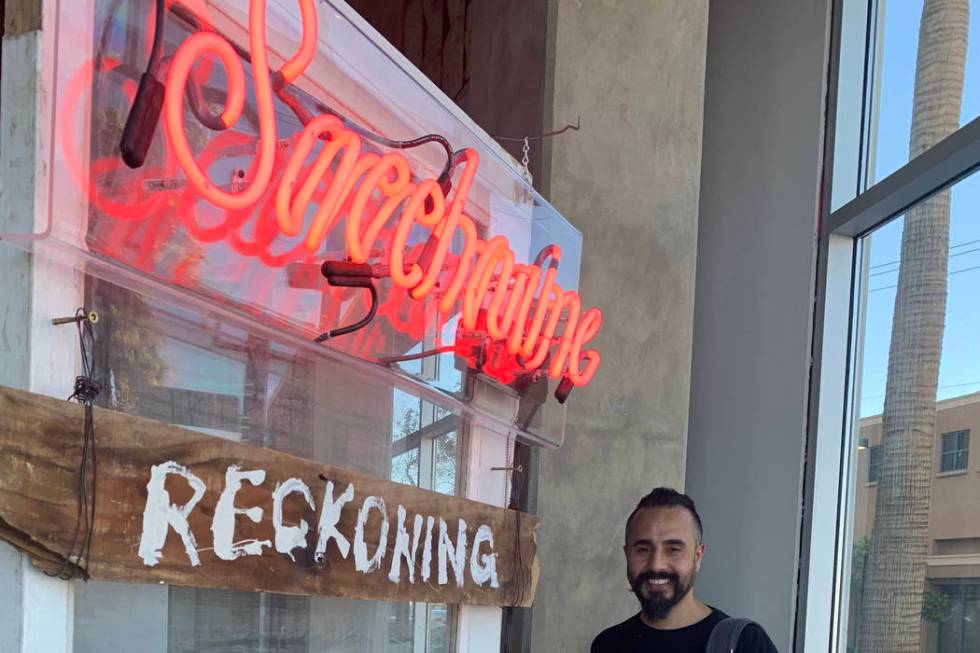 Ali Fathollahi stands next to his exhibit in the downtown area that will be available for viewi ...