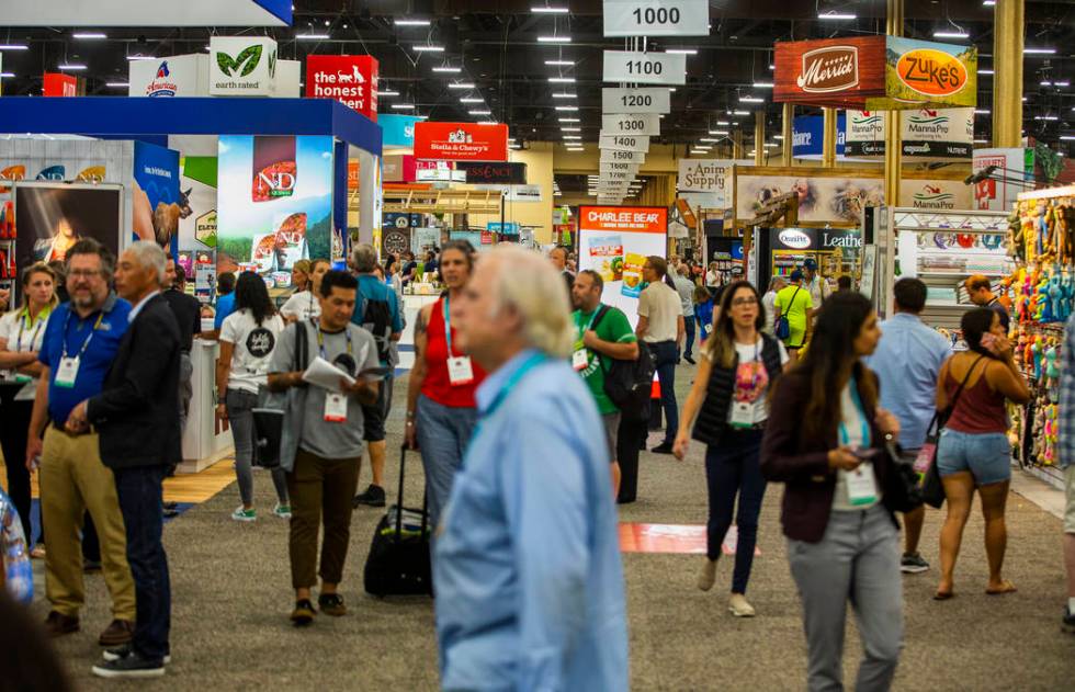 Attendees wander about one of the vast showroom floors of items at the SuperZoo pet products sh ...