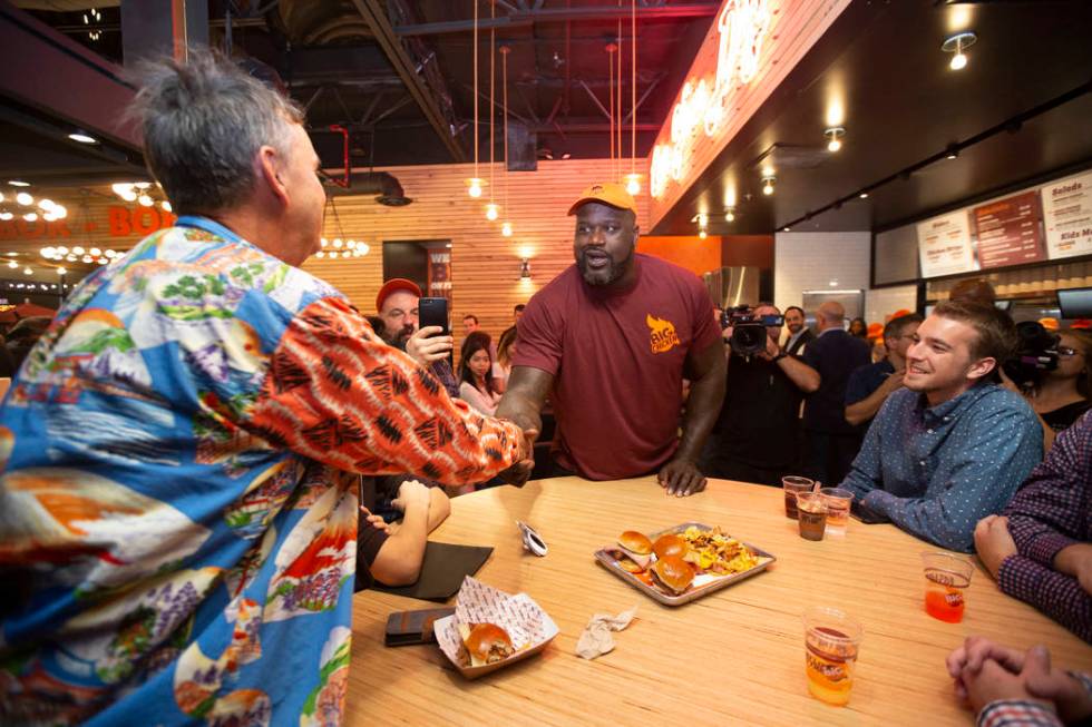 Shaquille O'Neal, center, greets guests during the grand opening celebration of Big Chicken, Sh ...