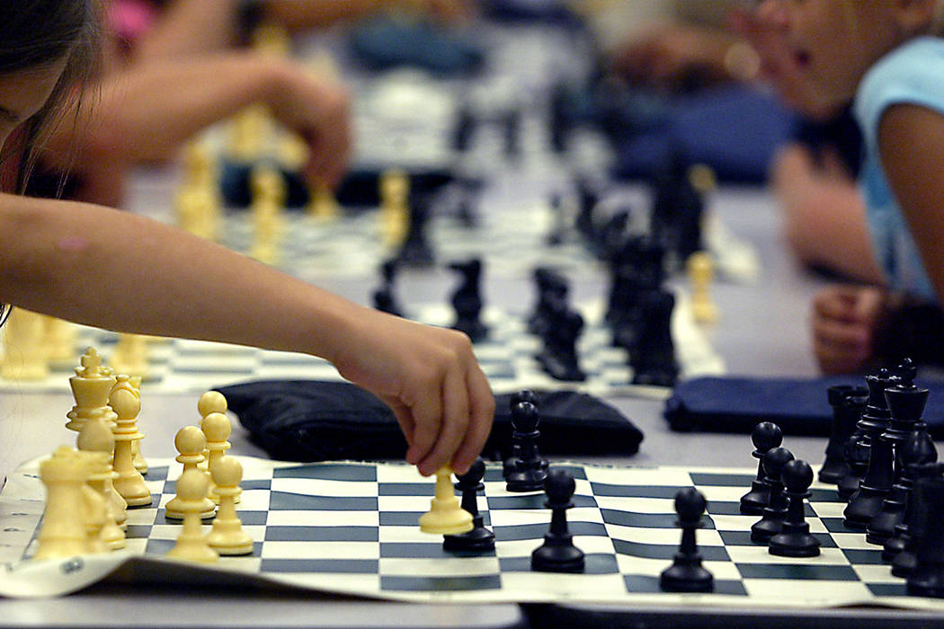 Groups of children play chess at the Wengert Elementary School during a Clark County Parks and ...